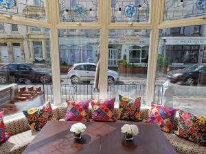 a table with pillows sitting in front of a window at The Bosworth House Hotel in Blackpool