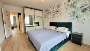 Posteľ alebo postele v izbe v ubytovaní Apartament Arkadia Augustow