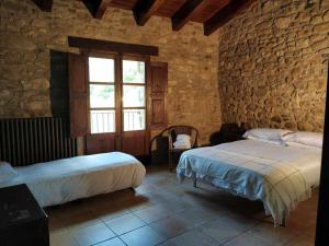 Postel nebo postele na pokoji v ubytování Mas Planella Casa Rural + 41 fotografií