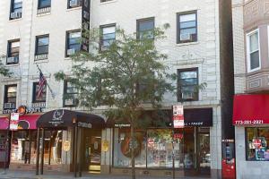 a building on a city street with stores at City Suites Hotel in Chicago