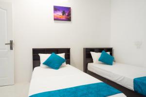 Letto o letti in una camera di Palm Gate Maldives