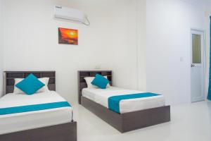 Letto o letti in una camera di Palm Gate Maldives