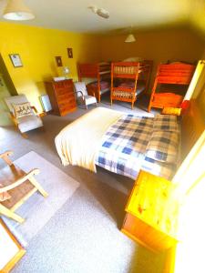 a bedroom with a bed and chairs in it at Slane Farm Hostel, Cottages and Camping in Slane