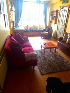 a living room with a couch and a coffee table at Slane Farm Hostel, Cottages and Camping in Slane