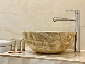 a bathroom with a large wooden bowl sink at Charming Madrid Studio - Largas Estancias in Madrid