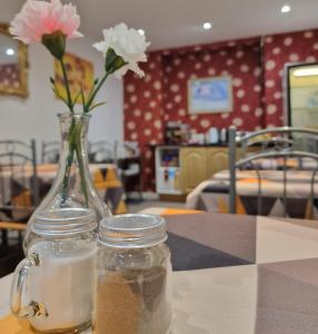 a vase with flowers in it sitting on a table at The Bosworth House Hotel in Blackpool