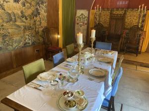 una mesa con platos de comida encima en Buittle Castle Exclusive Use- Stay in your own Castle! en Castle Douglas