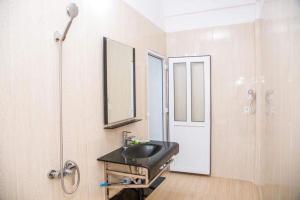 a bathroom with a sink and a mirror at Nhà nghỉ Đức Trọng in Móng Cái