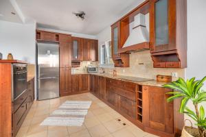 a kitchen with wooden cabinets and a stainless steel refrigerator at Selûne Boutique Home in Skiathos