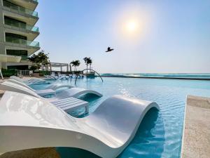 a water slide in a swimming pool at a resort at HiGuests - Superlative apt with private beach access in Dubai