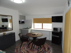 a kitchen with a table and chairs in a room at Braeview Studio in Macduff