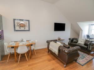 a living room with a couch and a table at Foxton Penthouse in Whitby