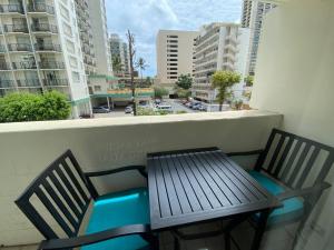 a balcony with a bench and a view of buildings at Kuhio Village Towers 2 410a in Honolulu