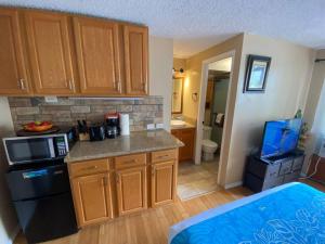 a kitchen with wooden cabinets and a counter top at Kuhio Village Towers 2 410a in Honolulu