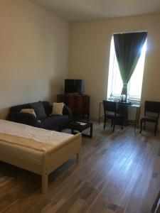 a living room with a bed and a couch and a table at Casa Miriam in Păuliş