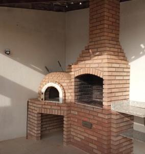 a brick oven in the corner of a room at Apartamento vista mar Atalaia todos quartos climatizados in Aracaju