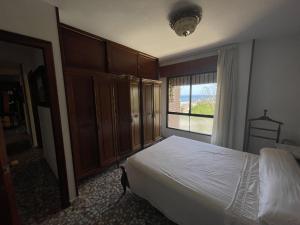 sypialnia z łóżkiem i dużym oknem w obiekcie PV20A, Gran apartamento en el centro con vistas al mar w mieście Villajoyosa