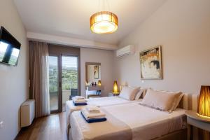 En eller flere senge i et værelse på Domus Eleon Luxury Villa