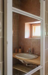 a bathroom with a sink and a mirror at Pinewood Guesthouse in Mäntsälä