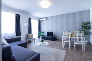 a living room with a couch and a table and chairs at Vagabond Corvin in Budapest