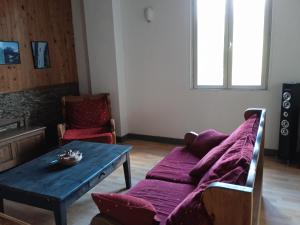 a living room with a couch and a table at gite la cordée in Lavans-lès-Saint-Claude