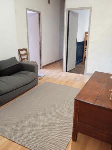 a living room with a couch and a coffee table at gite la cordée in Lavans-lès-Saint-Claude