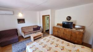 a living room with a bed and a couch at Apartment Cuhas with Terrace in Baška