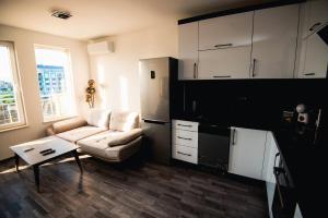 a living room with a couch and a table at Modern Spacious 1BD Apartment for two in Nesebar in Nesebar