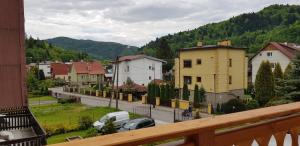 a view of a town with cars parked on a street at Willa Basinek in Muszyna