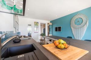 a kitchen with a bowl of fruit on a counter at Blue Luxury House Port Nature Naturiste in Cap d'Agde +10 photos