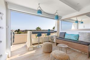 a living room with a couch and a large window at Blue Luxury House Port Nature Naturiste in Cap d'Agde