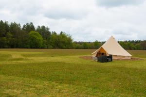 a large bell tent in a field of grass at Forest Edge Glamping in Gittisham