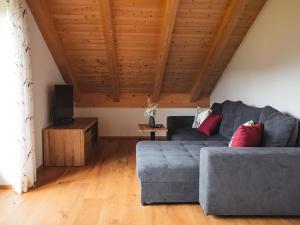 a living room with a couch and a tv at Ferienhof Kohler in Bichl