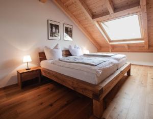 a bedroom with a large bed with a window at Ferienhof Kohler in Bichl