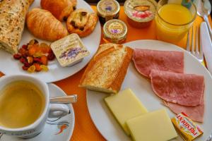 a plate of food with bread and cheese and a cup of coffee at Cap Nègre Hôtel in Le Lavandou