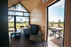 a living room with a couch and a table at Apartamenti Vējdzirnavas in Vārve