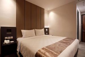 Voodi või voodid majutusasutuse Hayo Hotel Palembang toas