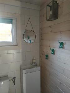 a bathroom with a toilet and a sink and a window at Lesne Runo Borsk in Borsk