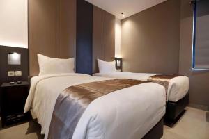 Voodi või voodid majutusasutuse Hayo Hotel Palembang toas