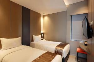 Voodi või voodid majutusasutuse Hayo Hotel Palembang toas