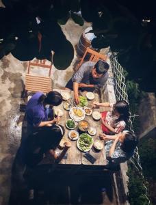 a group of people sitting around a table eating food at nhà Ba cơm Má in Phương Phi +72 photos