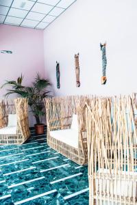 a room with chairs and fish on the wall at Poem Suites, Las Canteras in Las Palmas de Gran Canaria