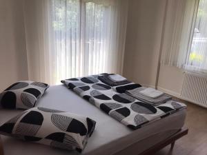 a bed with black and white sheets and pillows on it at Ihlamurlu Home in Sapanca +20 photos