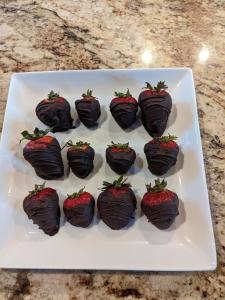 a plate of chocolate covered strawberries on a table at Maple Hill Manor Bed & Breakfast in Springfield