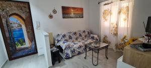 a living room with a couch and a table at Casa Diana in Augusta