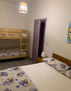 a bedroom with two bunk beds and a purple door at Casa di nonna Benedetta in Margherita di Savoia