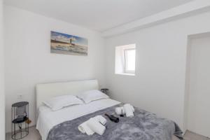 1 dormitorio blanco con 1 cama y 2 toallas en Apartman IVA, en Krivodol