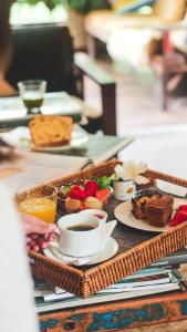 a tray with breakfast foods and coffee on a table at Work Hotel São Leopoldo in São Leopoldo