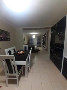 a kitchen and living room with a table and chairs at Hotel Vila Alvin & Apartments in Sarandë