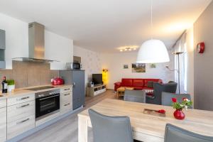 a kitchen and living room with a table and chairs at Ferienhaus Südheide in Hermannsburg